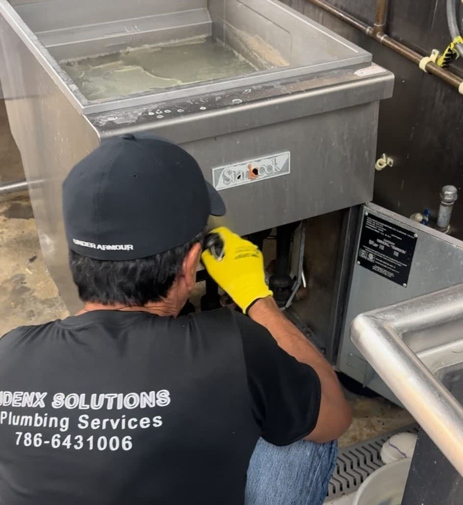 Plumber in Kendall working on a project